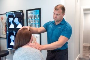 Chiropractor performing a neck evaluation