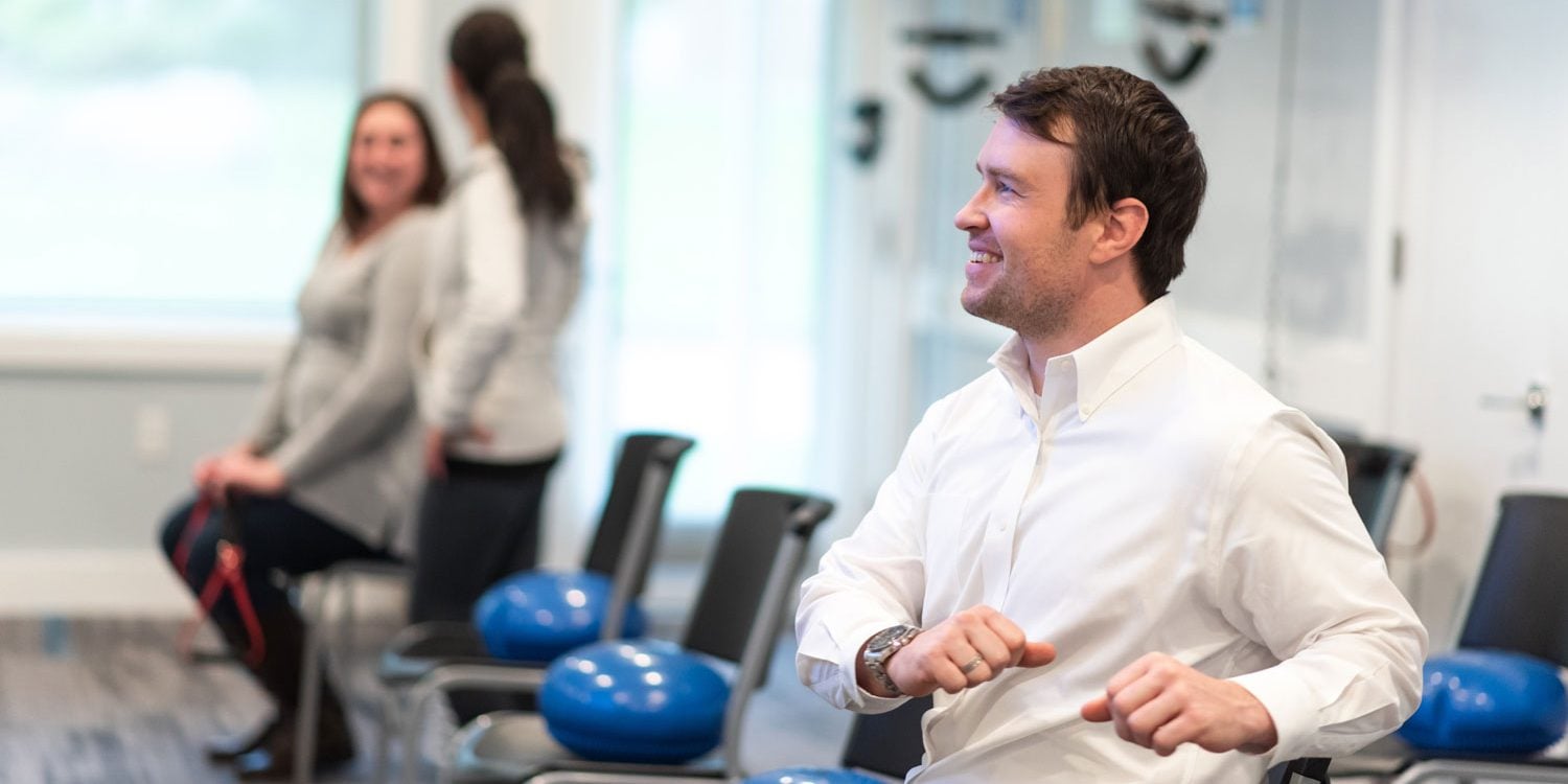 Patients doing warm up excercises before chiropractic exam